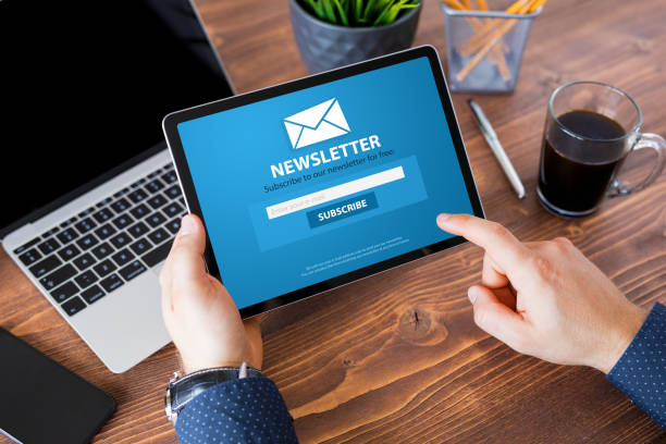 Man reading newsletter signup page on tablet computer